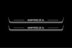 Two long door sill plates with Impreza lettering and edges illuminated in white, straight-on view on a dark background.