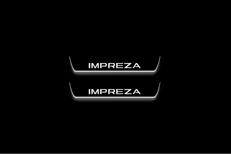 Two short door sill plates with Impreza lettering and edges illuminated in white, straight-on view on a dark background.