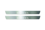 Two long silver-finished door sill plates with Impreza lettering on a light background, straight-on view.