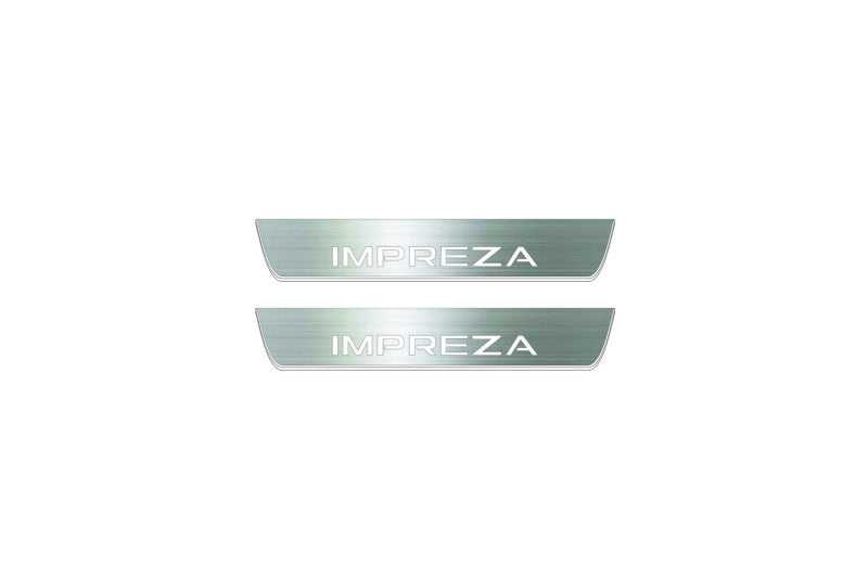 Two short silver-finished door sill plates with Impreza lettering on a light background, straight-on view.