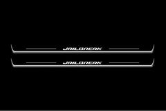 Two long door sill plates with Jailbreak lettering and edges illuminated in white, straight-on view on a dark background.
