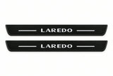Catalogue illustration of two front black Matte PRO LED door sill plates with illuminated Laredo lettering for Jeep Grand Cherokee WK2; dimensions are selected during manufacture.