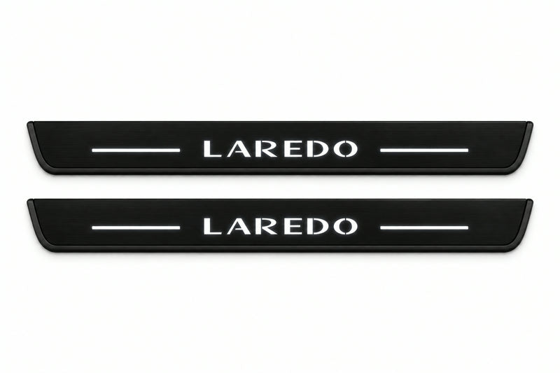 Catalogue illustration of two front black Matte PRO LED door sill plates with illuminated Laredo lettering for Jeep Grand Cherokee WK2; dimensions are selected during manufacture.