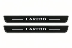 Catalogue illustration of two front black Matte PRO LED door sill plates with illuminated Laredo lettering for Jeep Grand Cherokee WK2; dimensions are selected during manufacture.
