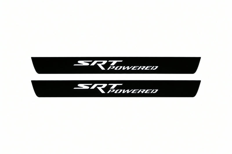 Catalogue illustration of two front black Matte PRO LED door sill plates with illuminated SRT POWERED lettering for Jeep Grand Cherokee WK2; dimensions are selected during manufacture.
