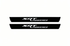 Catalogue illustration of two front black Matte PRO LED door sill plates with illuminated SRT POWERED lettering for Jeep Grand Cherokee WK2; dimensions are selected during manufacture.