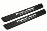 Catalogue illustration of two front black Matte PRO LED door sill plates with illuminated TrackHawk Supercharged lettering for Jeep Grand Cherokee WK2; dimensions are selected during manufacture.