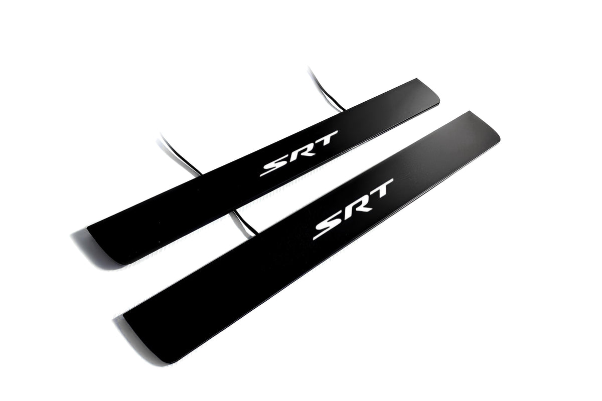 Two black door sill plates with red SRT lettering and visible wiring on a light background.