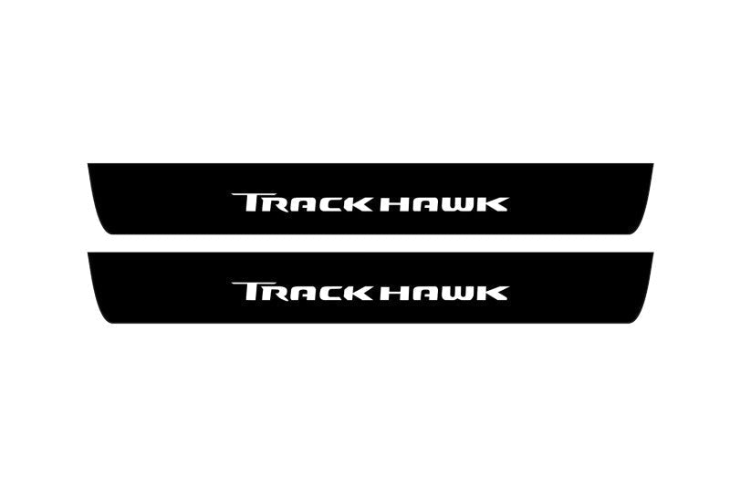 Catalog illustration of two black front door sill plates with Trackhawk lettering.
