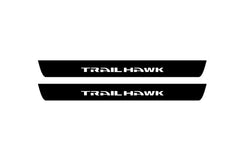 Catalog illustration of two black front door sill plates with Trailhawk lettering.
