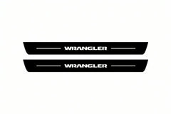 Catalogue illustration of two front black Matte PRO LED door sill plates with illuminated Wrangler lettering for Jeep Wrangler JK; dimensions are selected during manufacture.