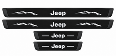 Catalogue illustration of two long black Matte PRO front sill plates with Jeep lettering and mountain graphics, plus two shorter rear plates with Jeep lettering and lines. White top lettering illuminated; side edges unlit. Vehicle-specific dimensions are not depicted. FRONT option includes front plates only.
