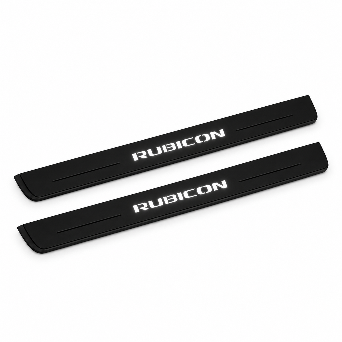 Catalogue illustration of two black Matte PRO front door sill plates with white RUBICON lettering illuminated only on top. Edges are unlit; rear plates for FRONT+REAR are not pictured. Final dimensions are selected for Wrangler JL during manufacture.