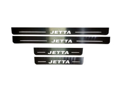 Four reflective door sill plates with white Jetta lettering and horizontal lines.