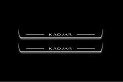 Two long door sill plates with Kadjar lettering and edges illuminated in white, straight-on view on a dark background.