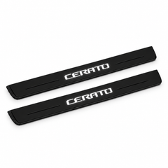 Catalogue illustration of two black Matte PRO front door sill plates with stylised illuminated CERATO lettering on the top surface. Edges are unlit; rear plates for FRONT+REAR are not pictured. Final dimensions are selected for Kia Cerato Sedan YD during manufacture.