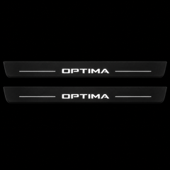 Catalogue illustration of two black Matte PRO front door sill plates with illuminated OPTIMA lettering and short lines on the top surface. Rear plates are not pictured; final dimensions are selected for the vehicle.