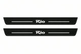 Catalogue illustration of two front black Matte PRO LED door sill plates with illuminated Rio lettering for Kia Rio II; dimensions are selected during manufacture.