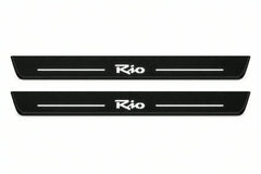 Catalogue illustration of two front black Matte PRO LED door sill plates with illuminated Rio lettering for Kia Rio II; dimensions are selected during manufacture.