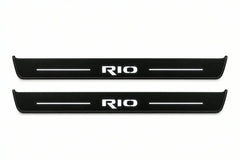 Catalogue illustration of two front black Matte PRO LED door sill plates with illuminated Rio lettering for Kia Rio IV; dimensions are selected during manufacture.