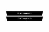 Catalogue illustration of two black Matte PRO front door sill plates with illuminated Stinger script lettering on top; side and bottom edges are unlit. Rear plates for a FRONT+REAR set are not shown. Final dimensions are selected for the Kia Stinger CK.