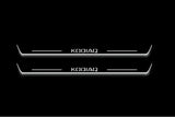 Two long door sill plates with Kodiaq lettering and edges illuminated in white, straight-on view on a dark background.