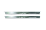 Two long silver-finished door sill plates with Kodiaq lettering on a light background, straight-on view.