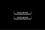 Two short door sill plates with Koleos lettering and edges illuminated in white, straight-on view on a dark background.