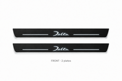 Lancia Delta Matte PRO catalogue illustration: two flat black FRONT plates with illuminated cursive Delta lettering on white