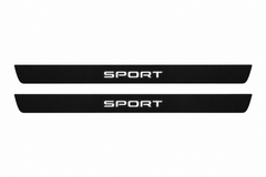 Catalogue illustration of two black Matte PRO front door sill plates with white SPORT lettering illuminated only on top. Edges are unlit; rear plates for FRONT+REAR are not pictured. Final dimensions are selected for Discovery Sport L550 during manufacture.