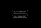Two short door sill plates with Landtrek lettering and edges illuminated in white, straight-on view on a dark background.
