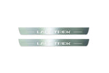 Two long silver-finished door sill plates with Landtrek lettering on a light background, straight-on view.