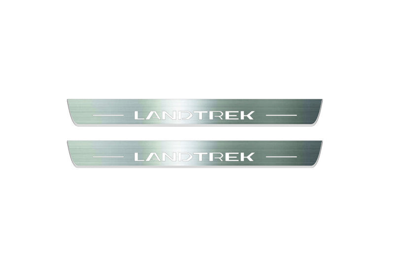 Two long silver-finished door sill plates with Landtrek lettering on a light background, straight-on view.