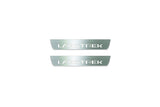 Two short silver-finished door sill plates with Landtrek lettering on a light background, straight-on view.