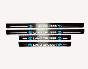 Toyota LC 200 2007+ illuminated entry guards in stainless steel with Land Cruiser logo