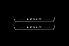 Two long door sill plates with Lexus lettering and edges illuminated in white, straight-on view on a dark background.