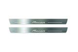 Two long silver-finished door sill plates with Macan lettering on a light background, straight-on view.