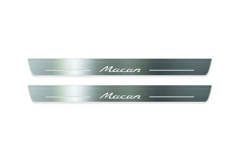 Two long silver-finished door sill plates with Macan lettering on a light background, straight-on view.