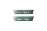 Two short silver-finished door sill plates with Macan lettering on a light background, straight-on view.