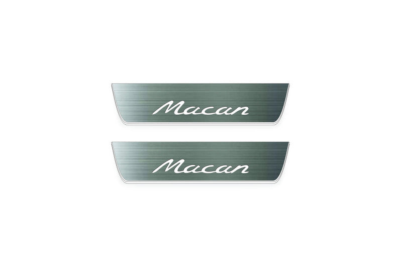Two short silver-finished door sill plates with Macan lettering on a light background, straight-on view.