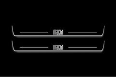 Two long door sill plates with Mach 1 lettering and edges illuminated in white, straight-on view on a dark background.