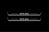 Two long door sill plates with Malibu lettering and edges illuminated in white, straight-on view on a dark background.