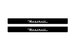 Catalog illustration of two black front door sill plates with Maserati lettering.