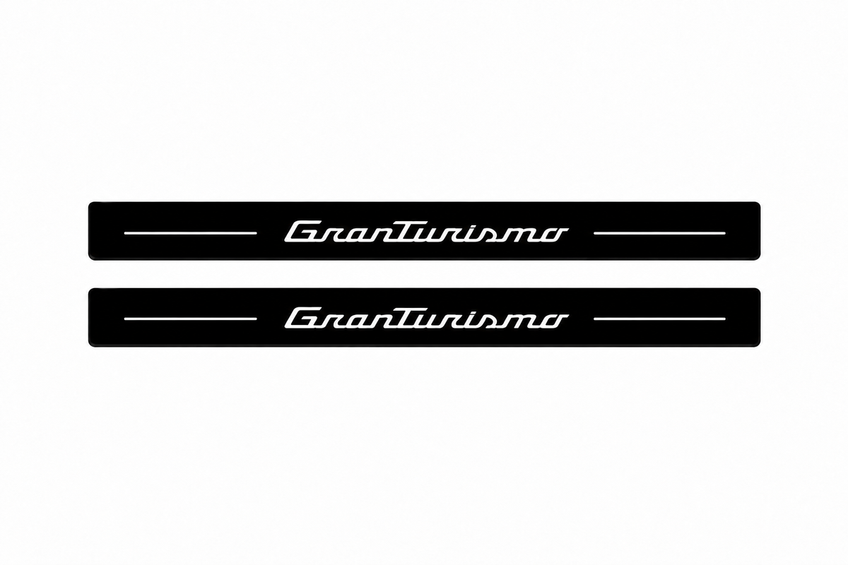 Catalogue demonstration of two black Matte PRO front sill plates with illuminated GranTurismo script and straight top lines. No rear plates are included or pictured; M145 dimensions are selected during manufacture.