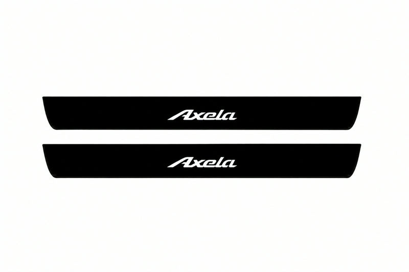 Catalogue illustration of two front black Matte PRO LED door sill plates with illuminated Axela lettering for Mazda 3 Sedan BM/BN; dimensions are selected during manufacture.