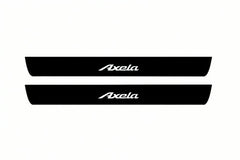 Catalogue illustration of two front black Matte PRO LED door sill plates with illuminated Axela lettering for Mazda 3 Sedan BM/BN; dimensions are selected during manufacture.