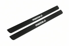 Catalogue illustration of two front black Matte PRO LED door sill plates with illuminated Mazda 6 lettering for Mazda 6 Sedan GH; dimensions are selected during manufacture.
