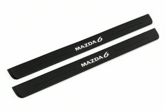 Catalogue illustration of two front black Matte PRO LED door sill plates with illuminated Mazda 6 lettering for Mazda6 Wagon GZ; dimensions are selected during manufacture.