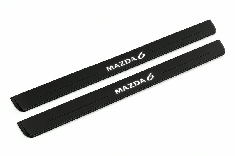 Catalogue illustration of two front black Matte PRO LED door sill plates with illuminated Mazda 6 lettering for Mazda6 Wagon GZ; dimensions are selected during manufacture.