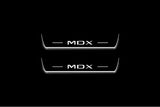 Two short door sill plates with MDX lettering and edges illuminated in white, straight-on view on a dark background.